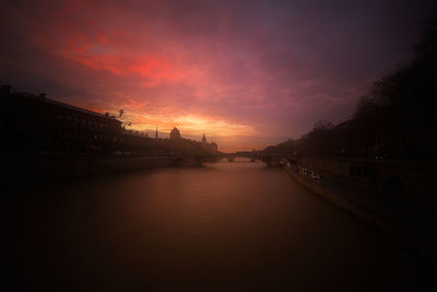 Bridge over river against sky during sunset