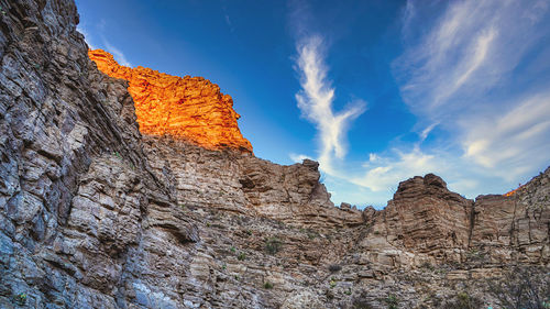 Low angle view of rock formations against sky