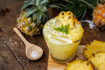 High angle view of pineapple slices on serving board at table 