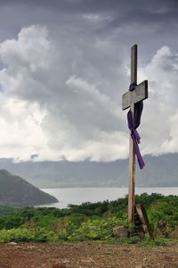 Traditional windmill on field against sky