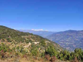 Scenic view of mountains against clear blue sky