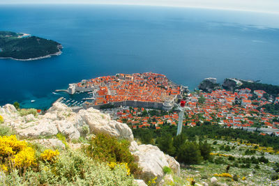 High angle view of rocks by sea against sky