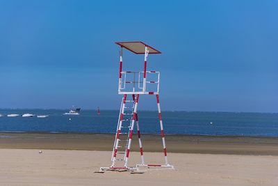 Lifeguard hut on beach against sky
