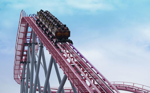 Low angle view of  roller coaster　against sky