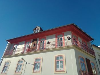 Low angle view of building against clear blue sky