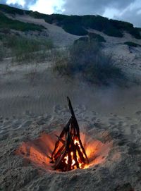 High angle view of bonfire on mountain against sky