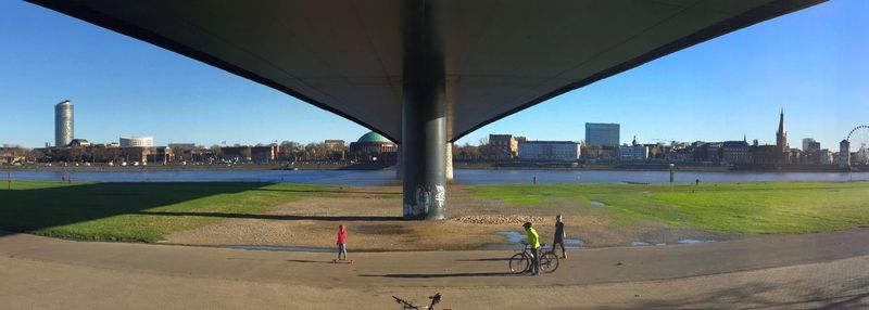 Scenic view of city by river against sky