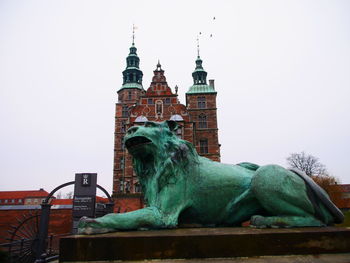 Low angle view of statue against building