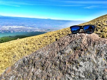 Scenic view of sunglasses on beach against sky