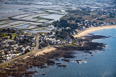 Aerial view of sea and buildings in city