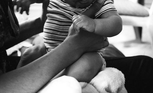 Close-up of mother with baby sitting