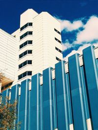 Low angle view of modern building against blue sky