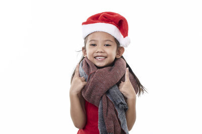 Portrait of cute girl wearing hat against white background