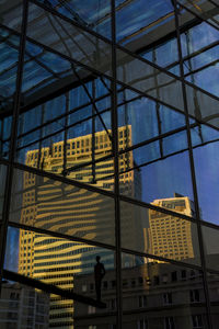 Low angle view of reflection of buildings in city