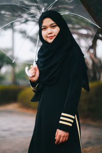 Young woman holding an umbrella