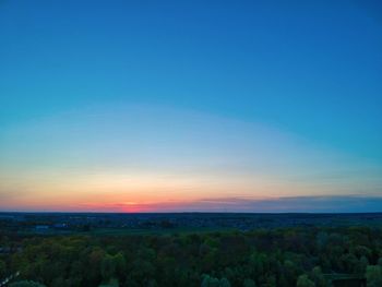 Scenic view of field against clear blue sky