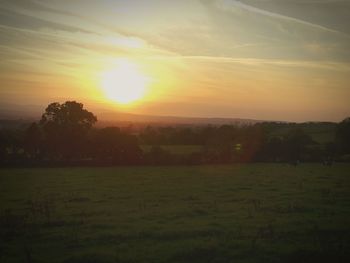 Scenic view of field against sky during sunset