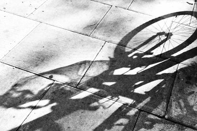 High angle view of shadow of bicycle