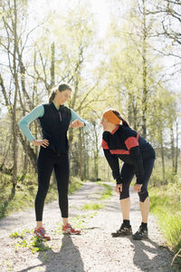 Woman checking time with sister after jogging