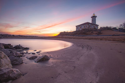 Scenic view of beach against sky during sunset