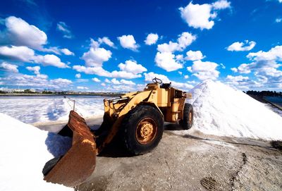 High angle view of machinery on snow covered land against sky