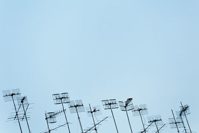 Low angle view of antenna against clear sky