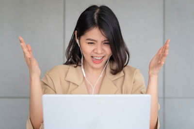 Woman using laptop while sitting on table