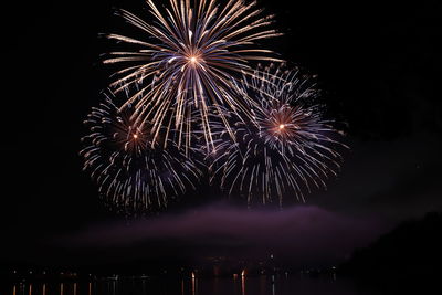 Low angle view of firework display at night