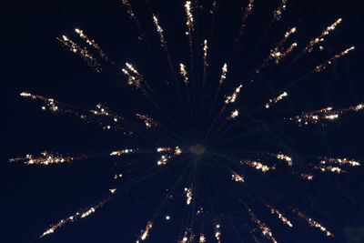 Low angle view of firework display at night