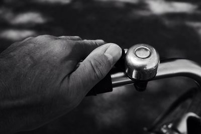 Cropped image of hand ringing bicycle bell