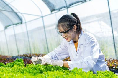 Woman working in greenhouse