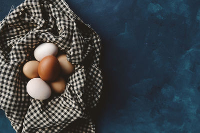 Directly above shot of person holding eggs in plate