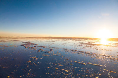 Scenic view of sea against clear sky during sunset