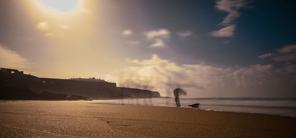 Scenic view of beach against sky during sunset