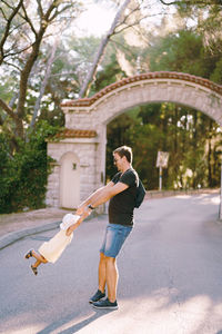 Side view of young woman walking on street