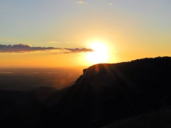 Scenic view of silhouette mountains against sky during sunset