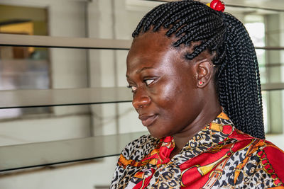 Africa woman sitting at a bus station waiting for her bus. location accra ghana west africa