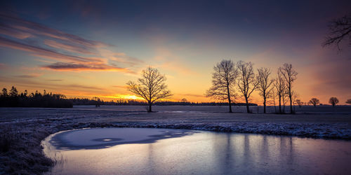 A beautiful frozen pond in the rural scene during the morning golden hour. 
