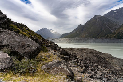 Scenic view of mountains and lake against cloudy sky