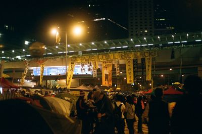 Crowd on illuminated city at night