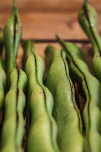 Close up of green beans on wooden table