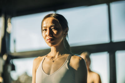 Portrait of young woman at yoga class in retreat center