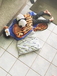 Low section of child on tiled floor at home