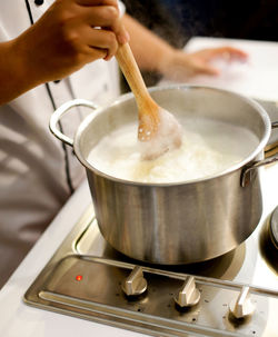 Close-up of person preparing food in kitchen at home