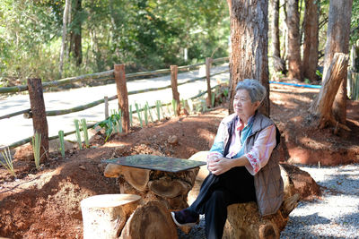 Asian old elderly female elder woman resting relaxing in park. senior leisure lifestyle