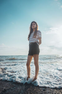 Full length of young woman on beach