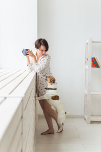 Man holding mobile phone at home