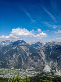 Scenic view of mountains against cloudy sky