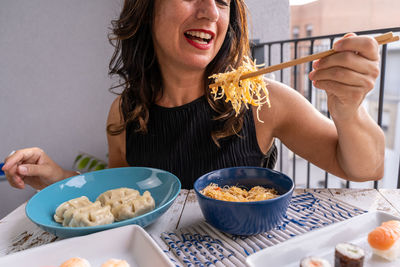 Portrait of woman having food at home