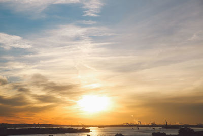 Scenic view of remote statue of liberty at sunset